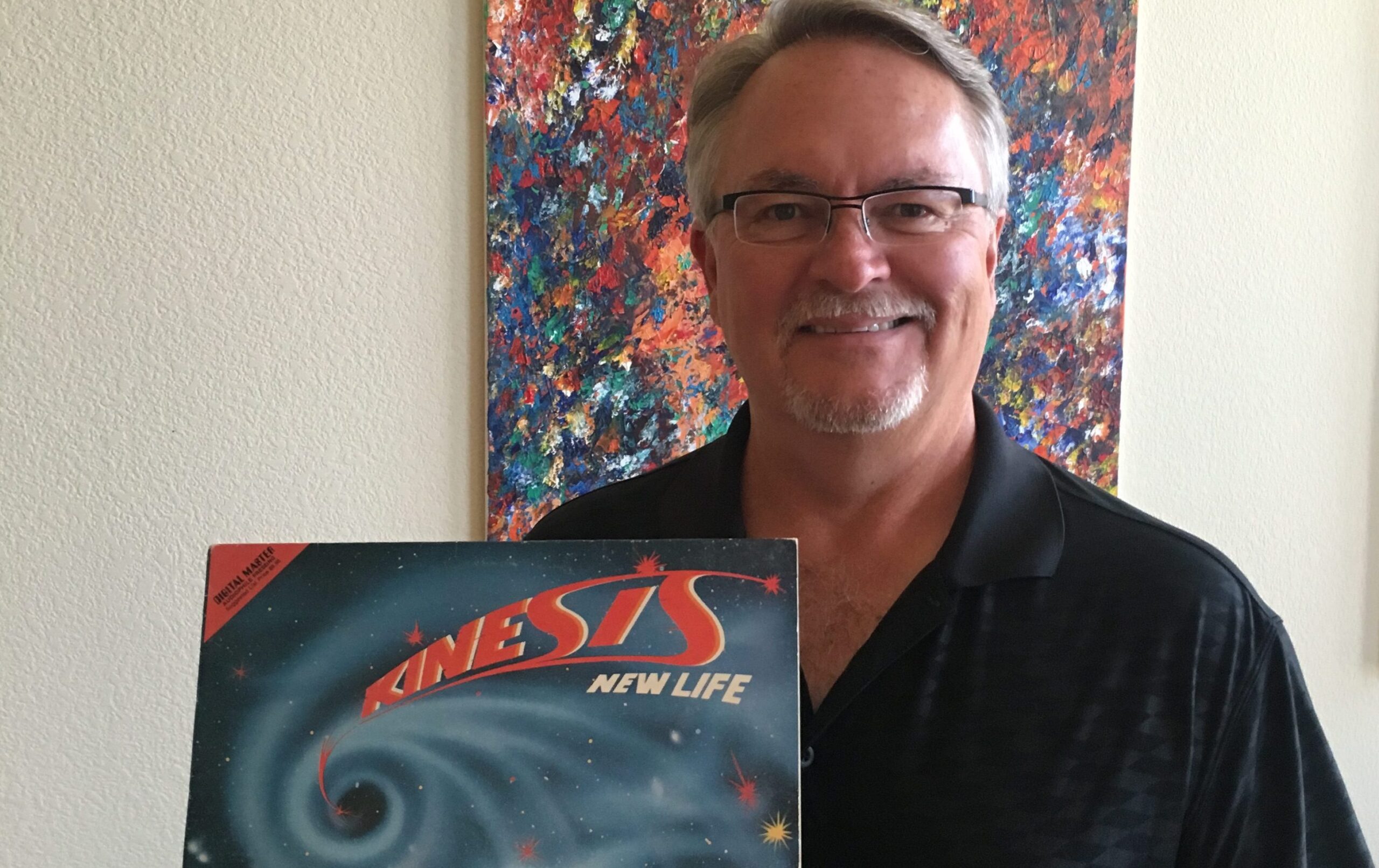 Photo of Ed Goodman with his album, Kinesis' New Life.