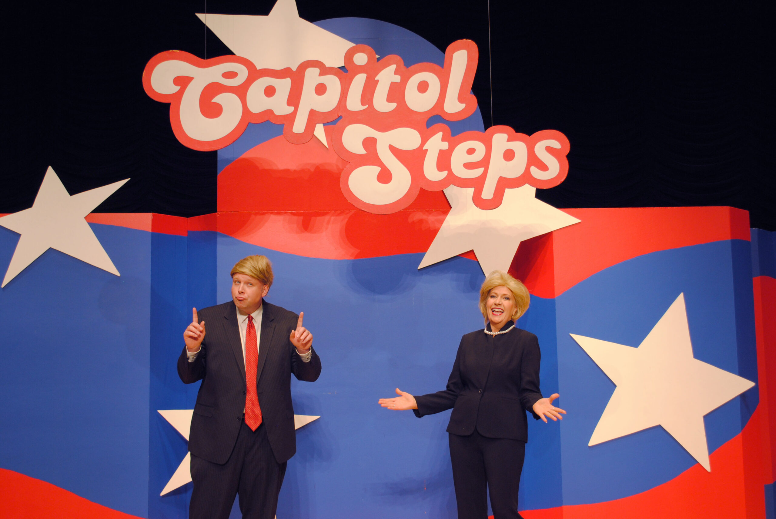 Donald Trump and Hilary Clinton impersantors on the Capitol Steps stage.