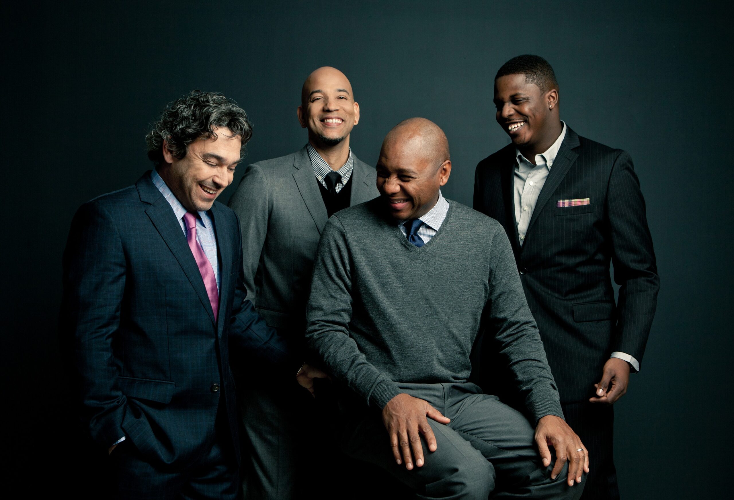 Four members of Branford Marsalis Quartet laughing.