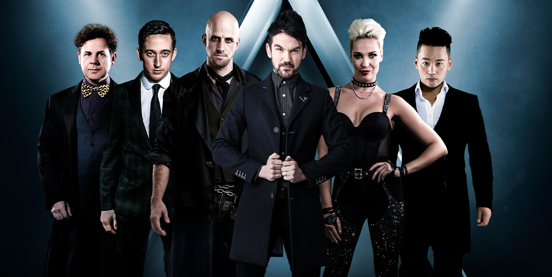 The Illusionists Live graphic featuring the magicians standing in front of two spotlights.