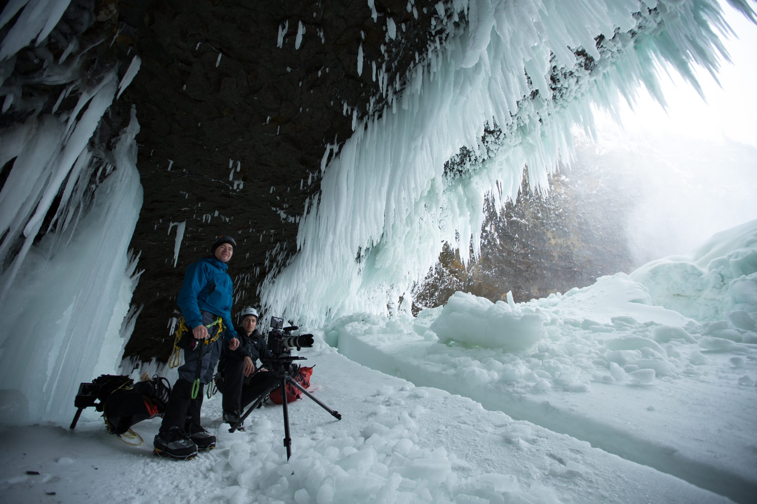 Bryan Smith taking a photo in an ice cave at Helmcken Falls.