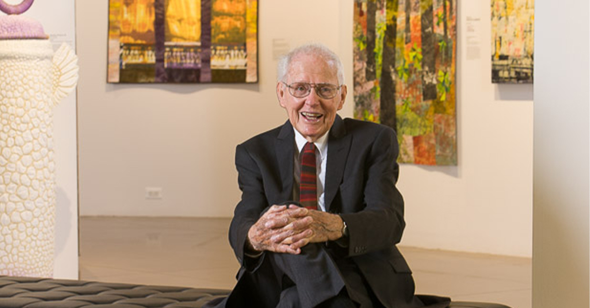 A photo of Jack Curfman sitting in The Lincoln Center Art Gallery.