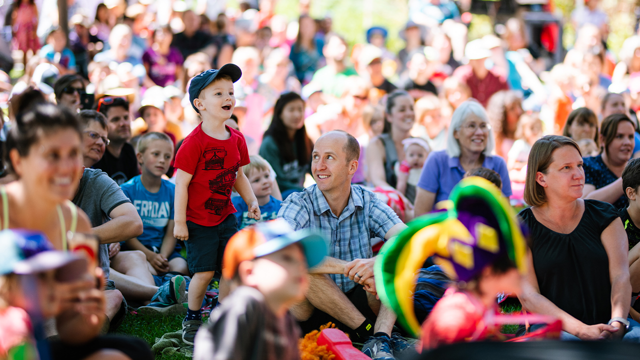 Child smiling and excited at a Children's Summer Series show.