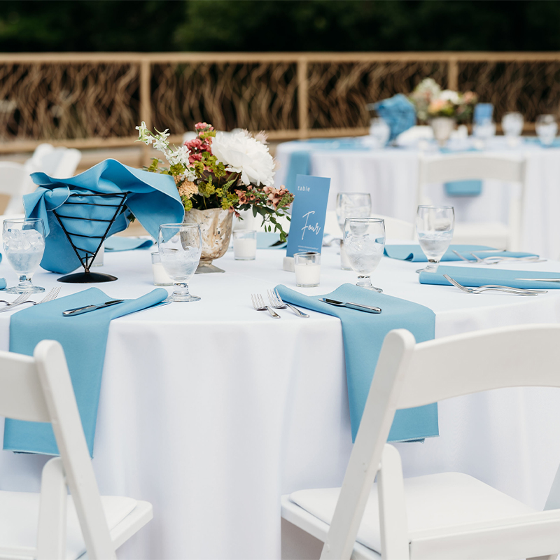 Blue and white table set up on the rooftop deck.