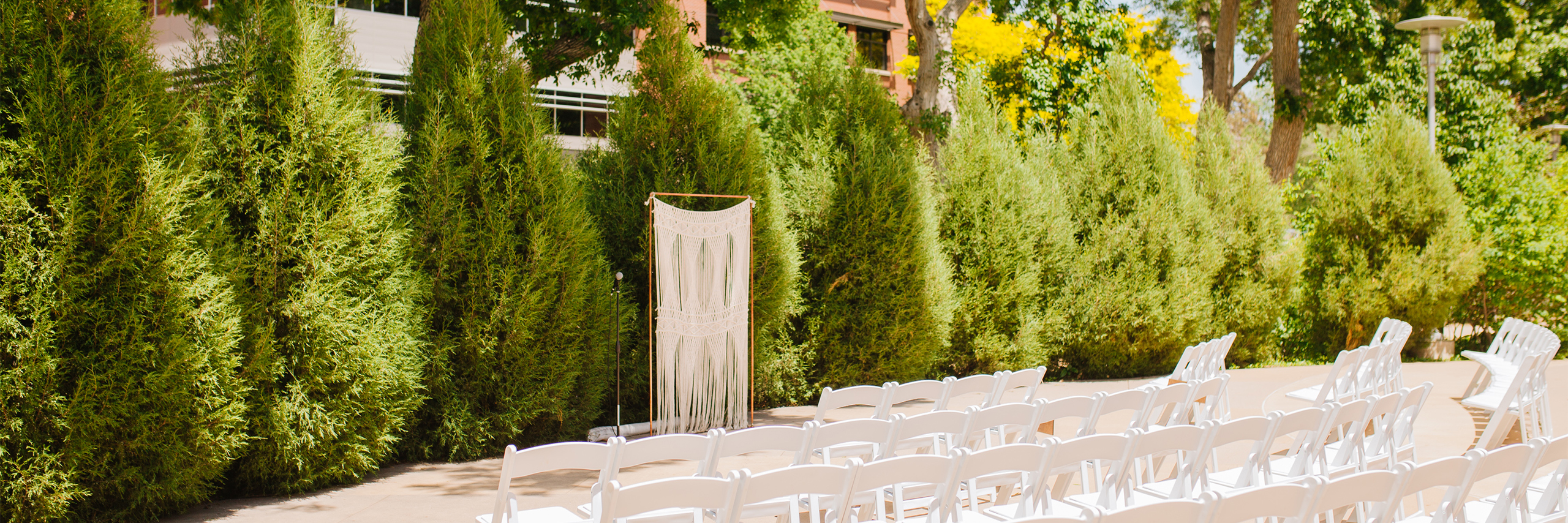 White chairs appear in rows for a wedding ceremony on the Terrace.