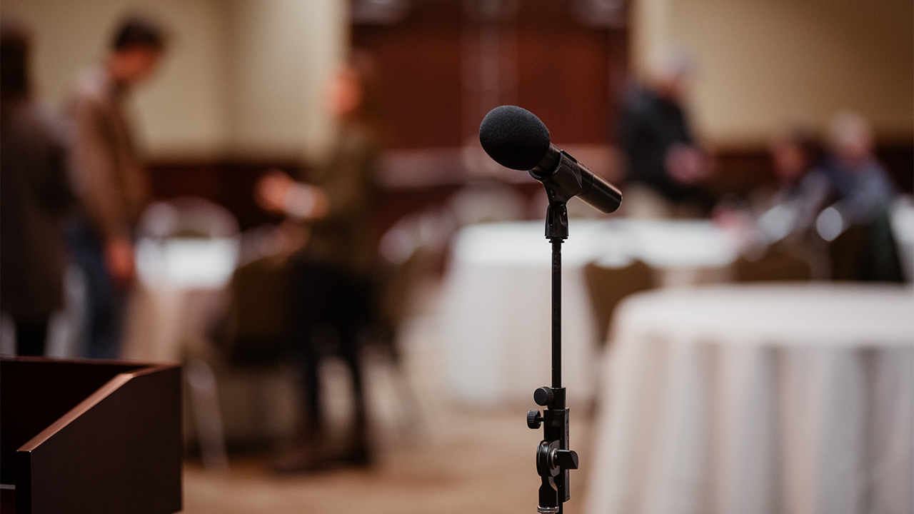 A lectern faces meeting attendees.