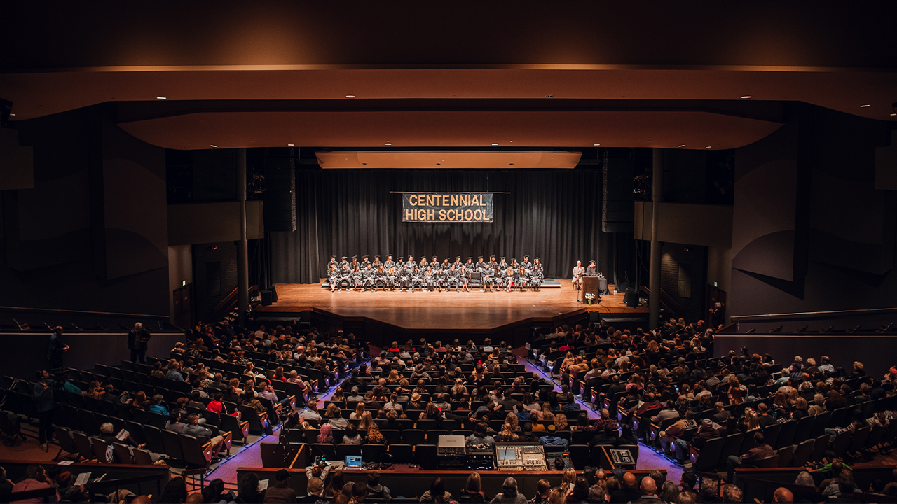 A graduation ceremony takes place in the Performance Hall.