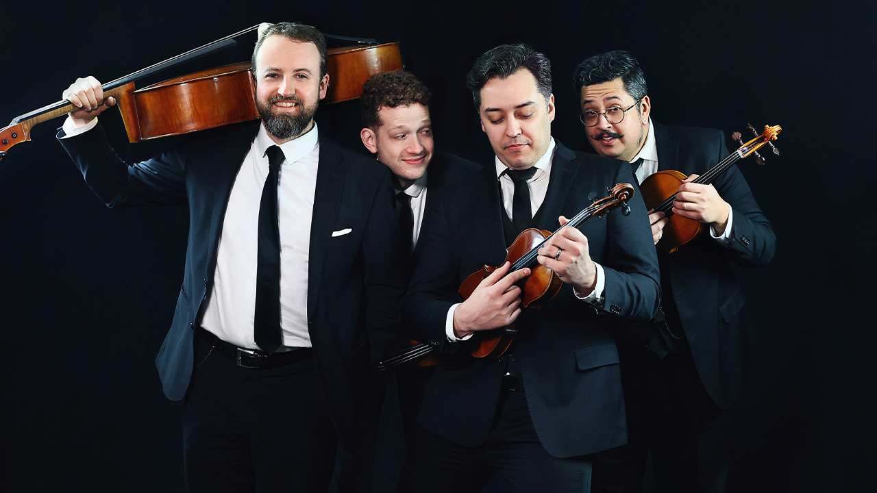 The members of Beo String Quartet smiling and holding their instruments.