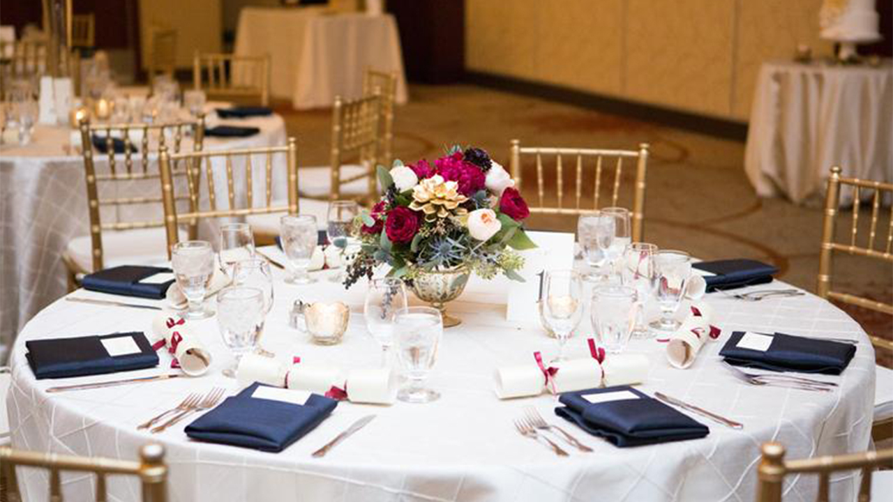 Round table decorated with flowers and wedding decor.