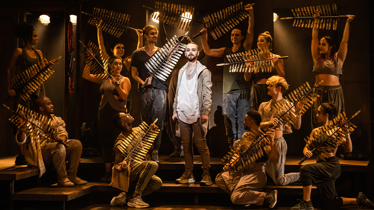 Jesus from Jesus Christ Superstar surrounded by gold palm branches.