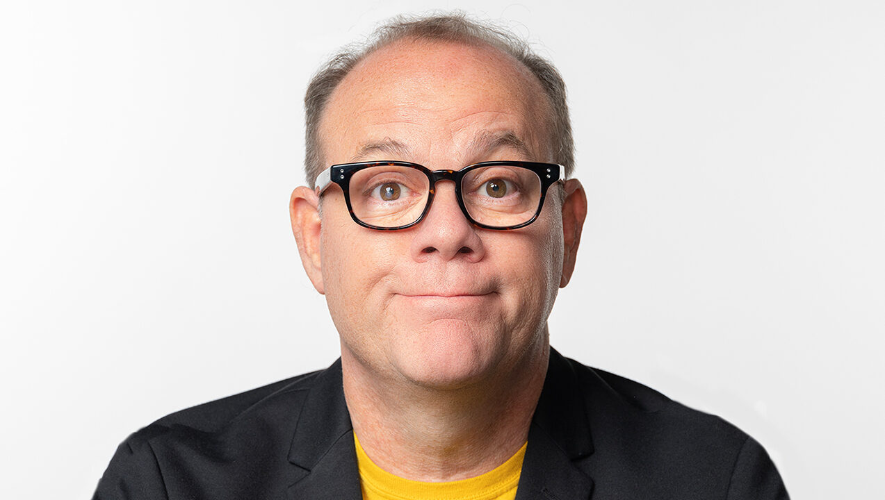 A headshot of Tom Papa half-smiling and raising his eyebrows.