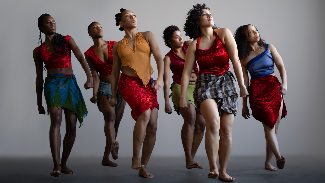 Cast photo of Urban Bush Women mid-dance step.