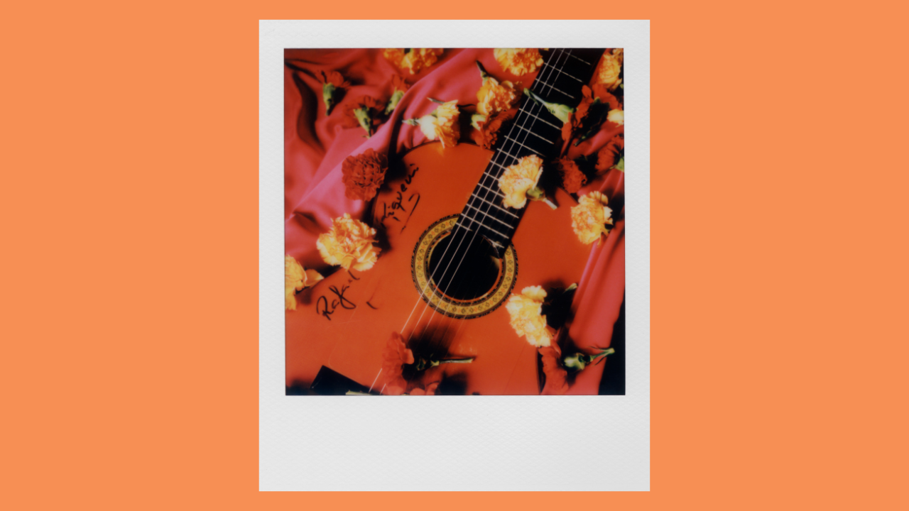 Polaroid photo of guitar with flowers signed by Rafael Riqueni.