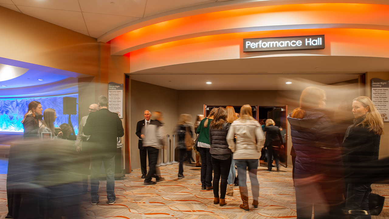 A busy Performance Hall lobby with patrons.