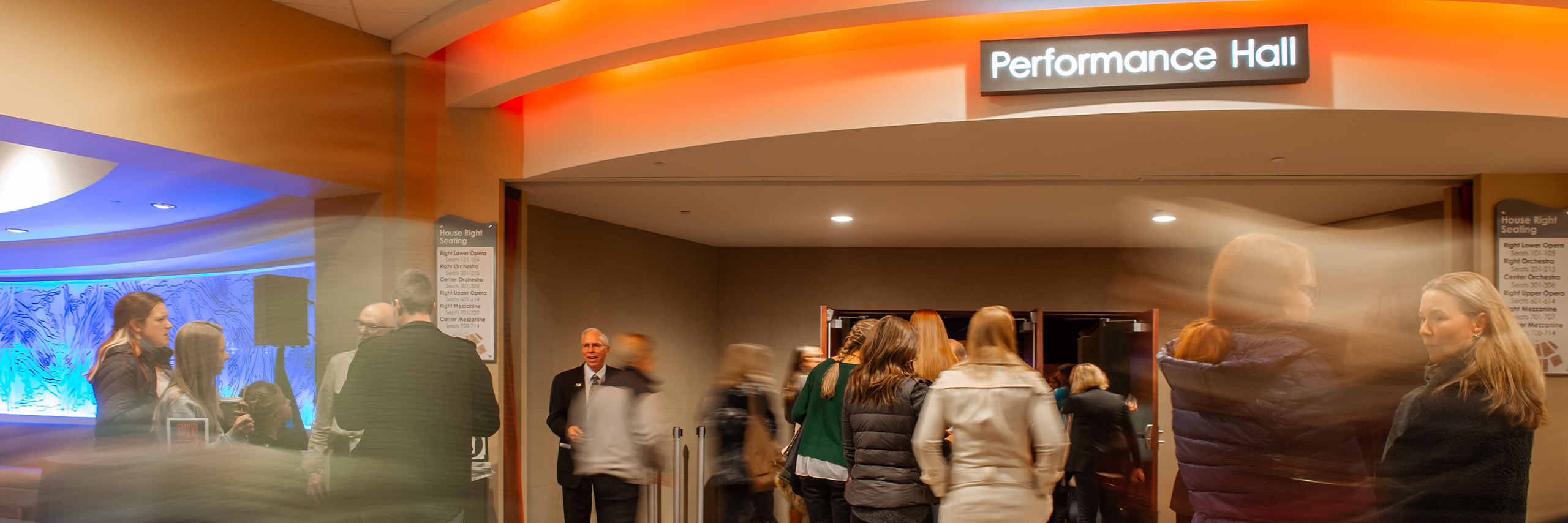 A busy Performance Hall lobby with patrons.