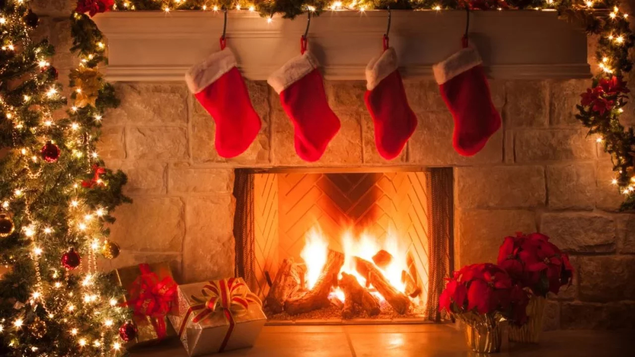 Four red stocking hanging over a fireplace.