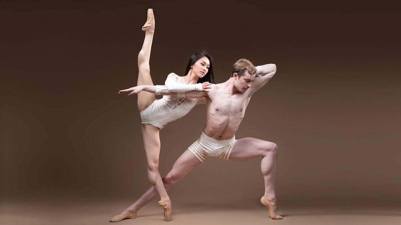 A man and a woman dancing with ballet shoes on.