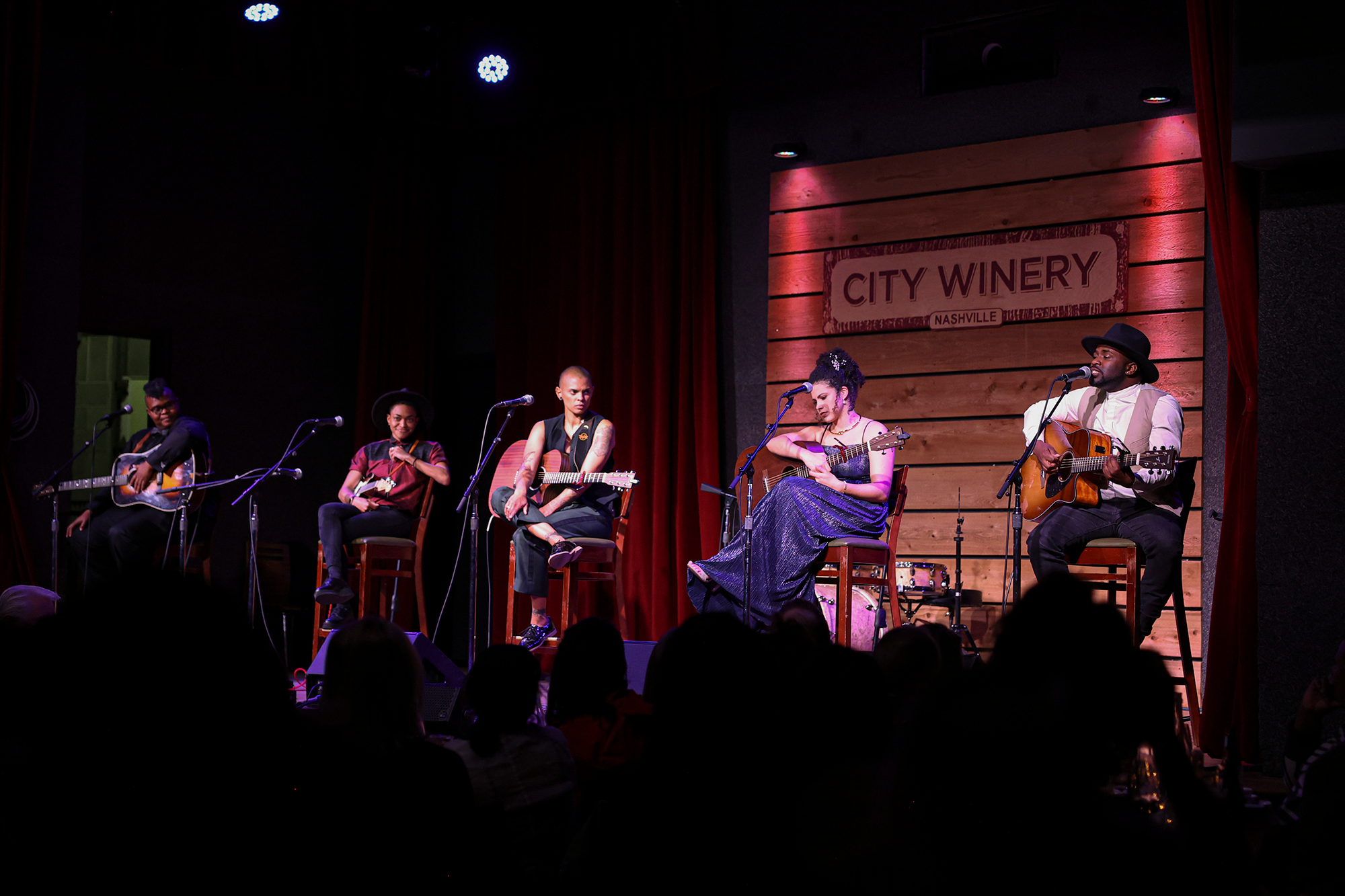 Five artists from the Black Opry on stage in a Writer's Round.