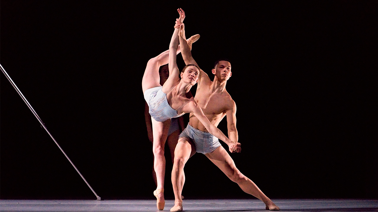 Two dancers in a dramatic athletic pose