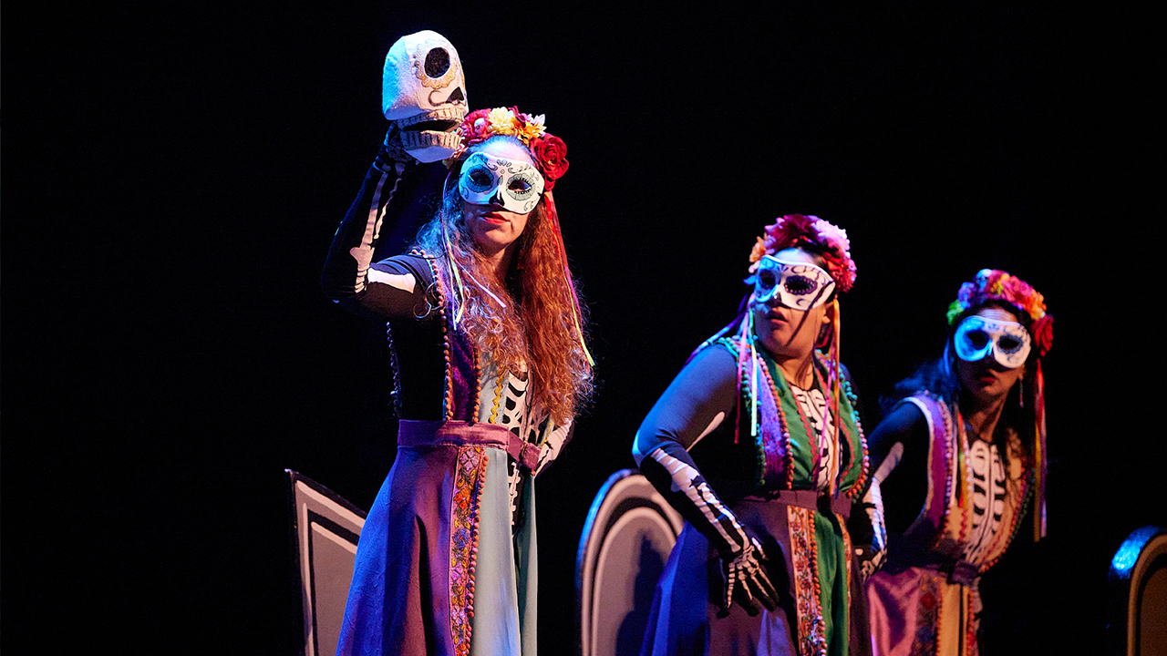 Día de Muertos candy skeletons looking at a sugar skull