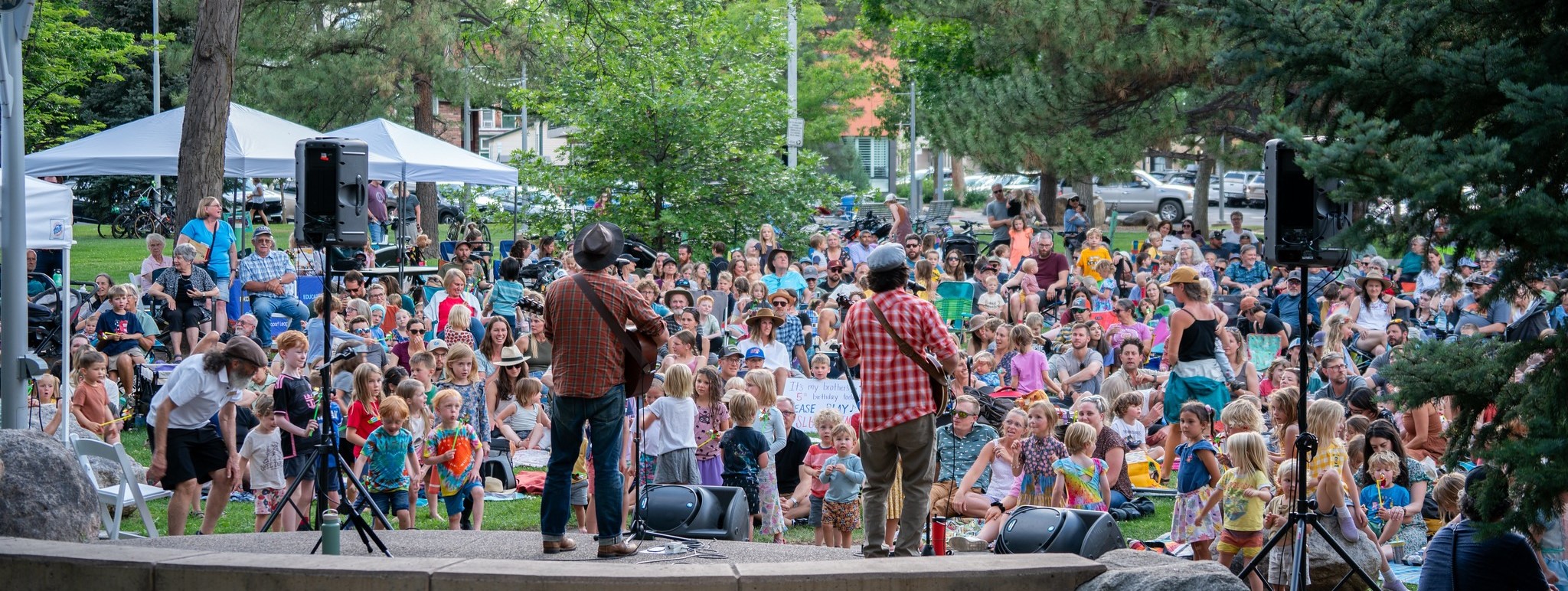 The Okee Dokee Brothers perform on stage at Library Park in Fort Collins, CO