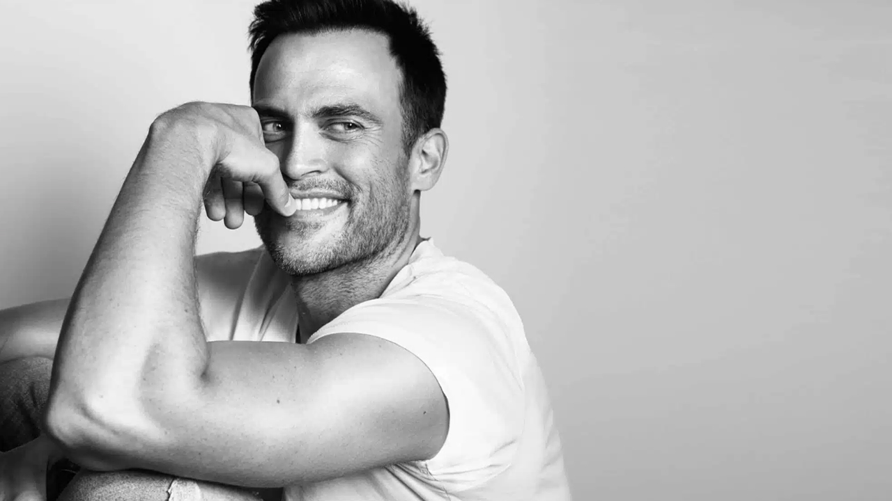 Cheyenne Jackson poses for a picture in a white t-shirt