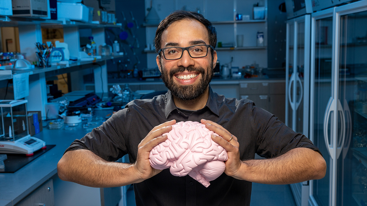 National Geographic Explorer Steve Ramirez holds a replica of the human brain