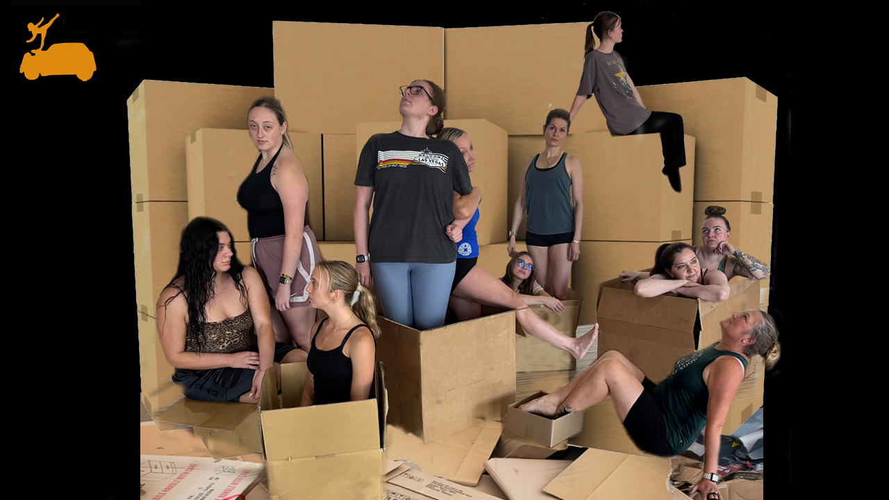 A group of dancers standing around cardboard boxes