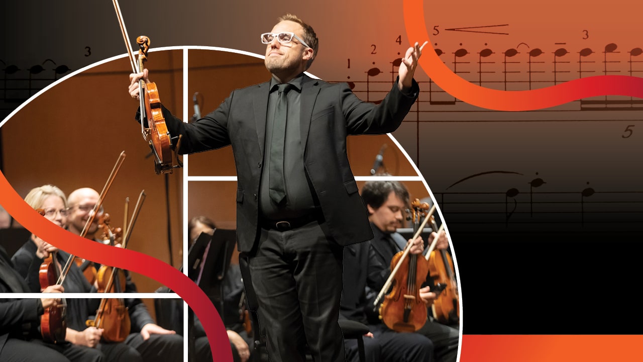 Concertmaster Byron Hitchcock stands in front of the orchestra with his violin