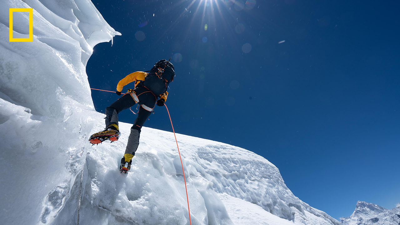 National Geographic Explorer scaling a frozen mountain