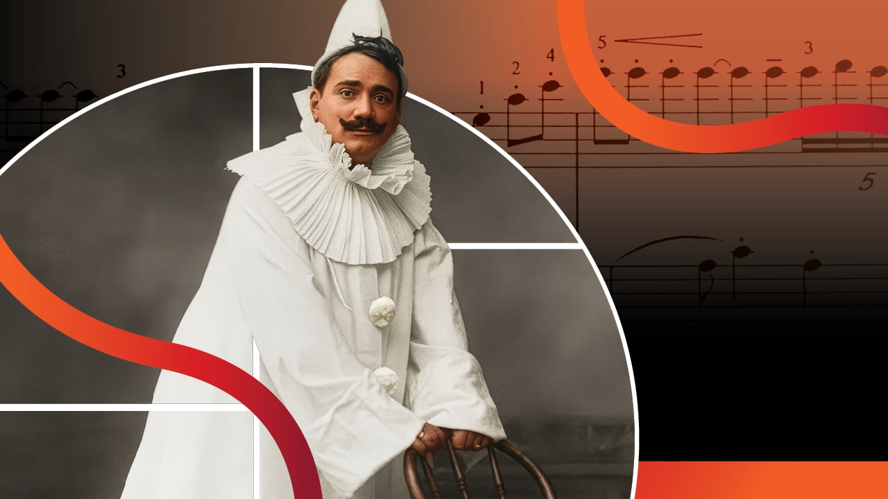 An actor dressed in a white clown's outfit