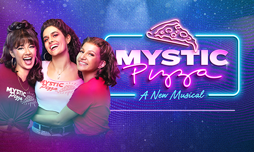 Three women smiling and hugging with the Mystic Pizza neon sign logo beside them.