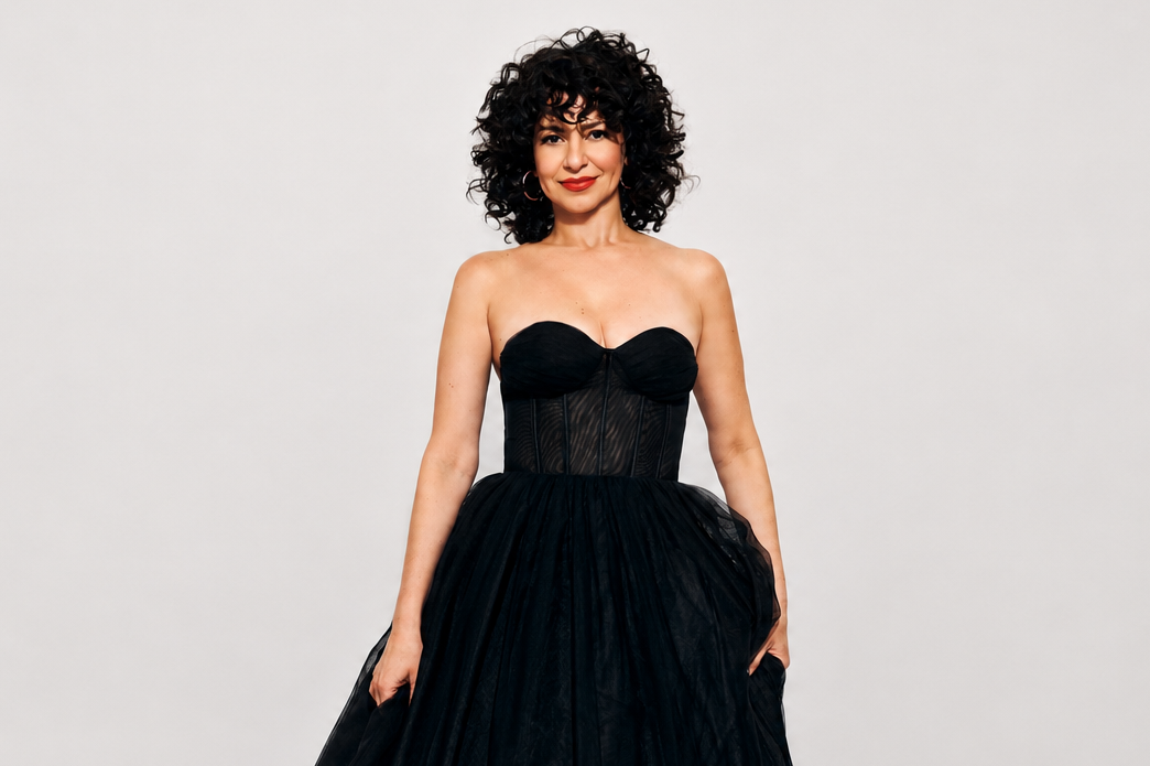 Mandy Gonzales standing in a black dress with a smile.