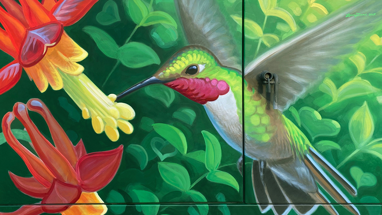 a mural of a humming bird drinking from a flower