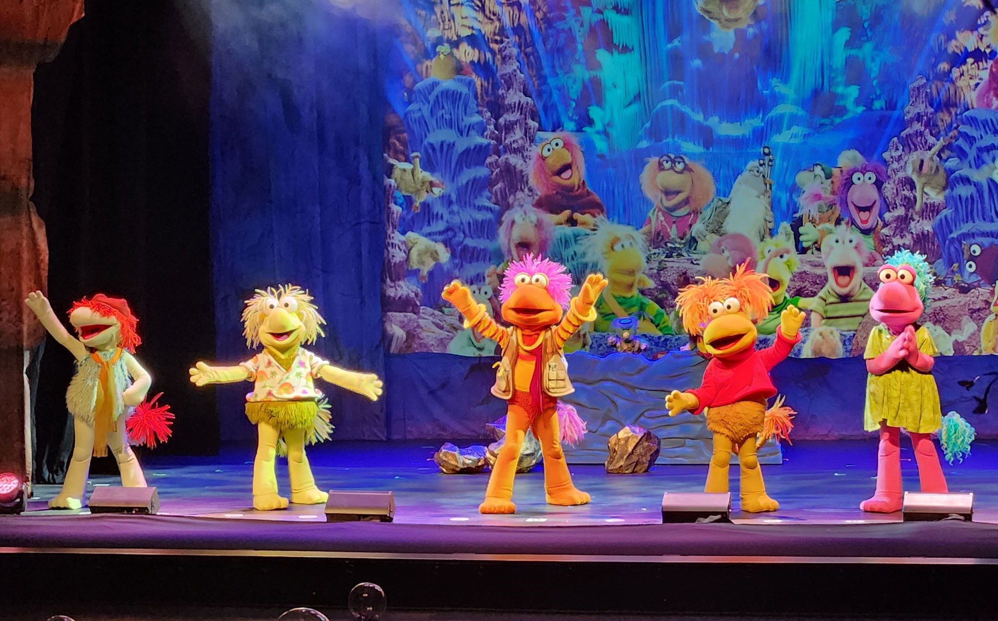 Five muppet characters on a stage